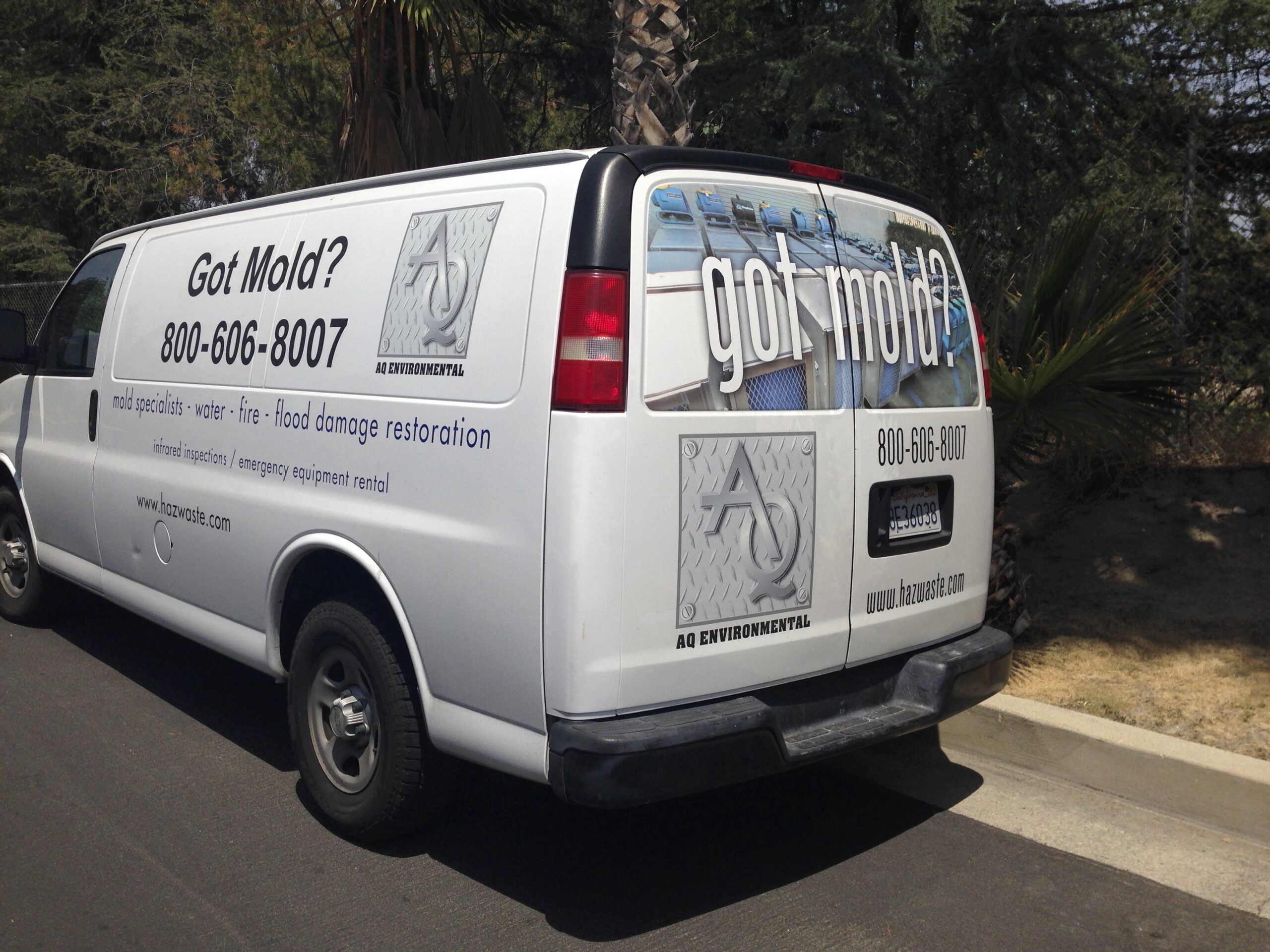 Van displaying "Got Mold?" slogan and contact information for AQ Environmental, offering mold and water damage restoration services.