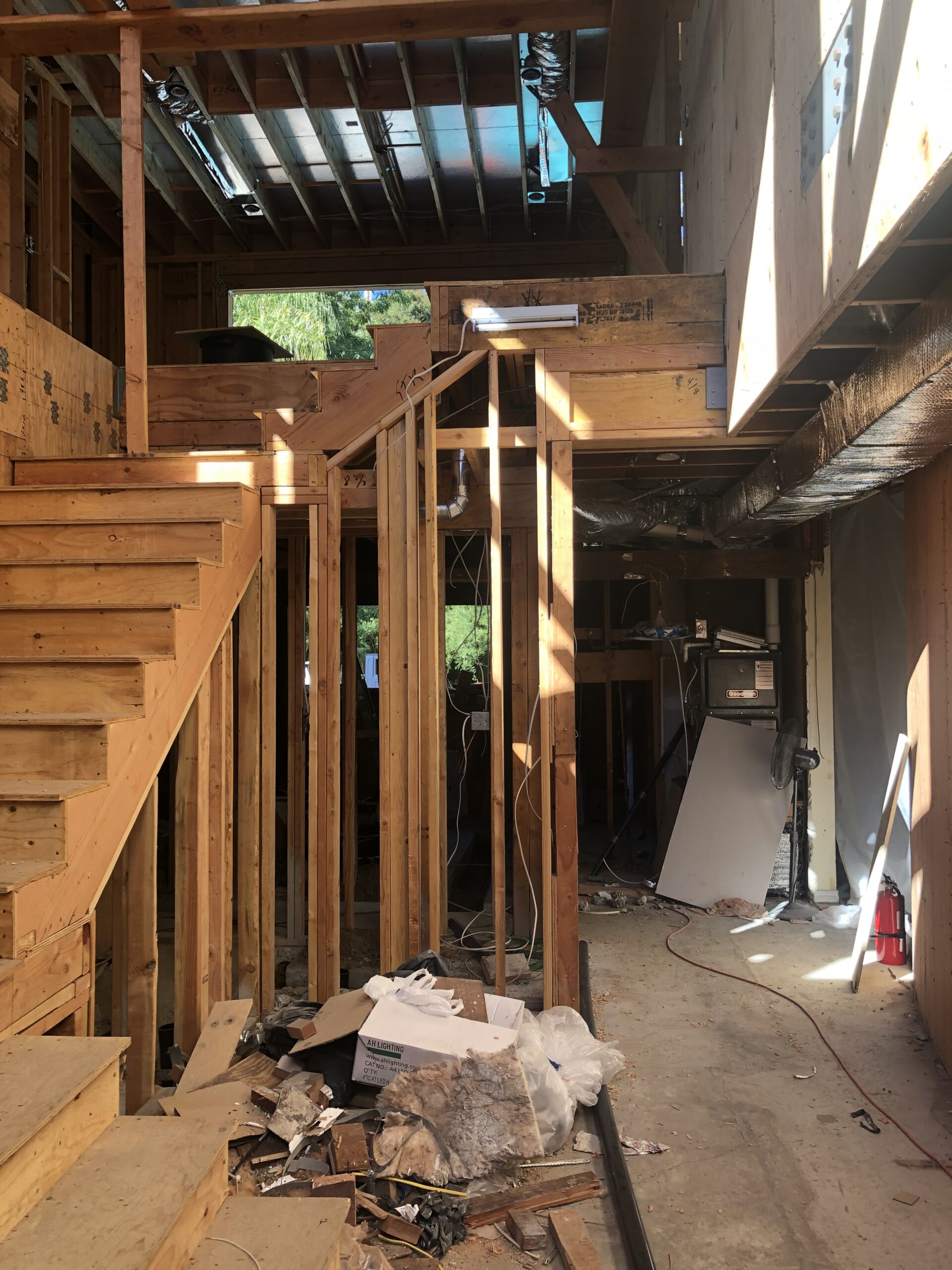 View of an unfinished interior construction site featuring exposed wooden framing