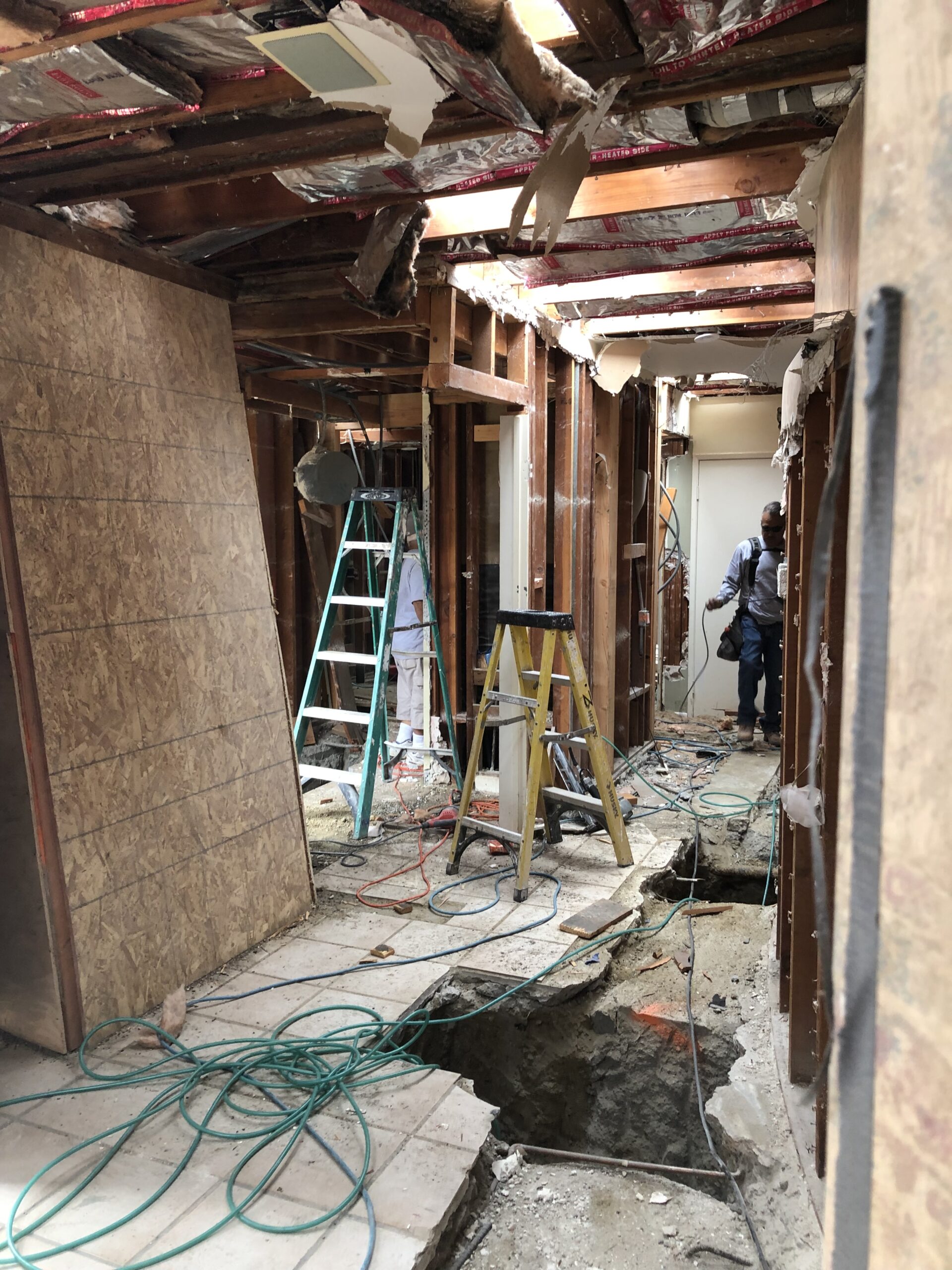Renovation in progress, featuring exposed walls and ceiling beams.
